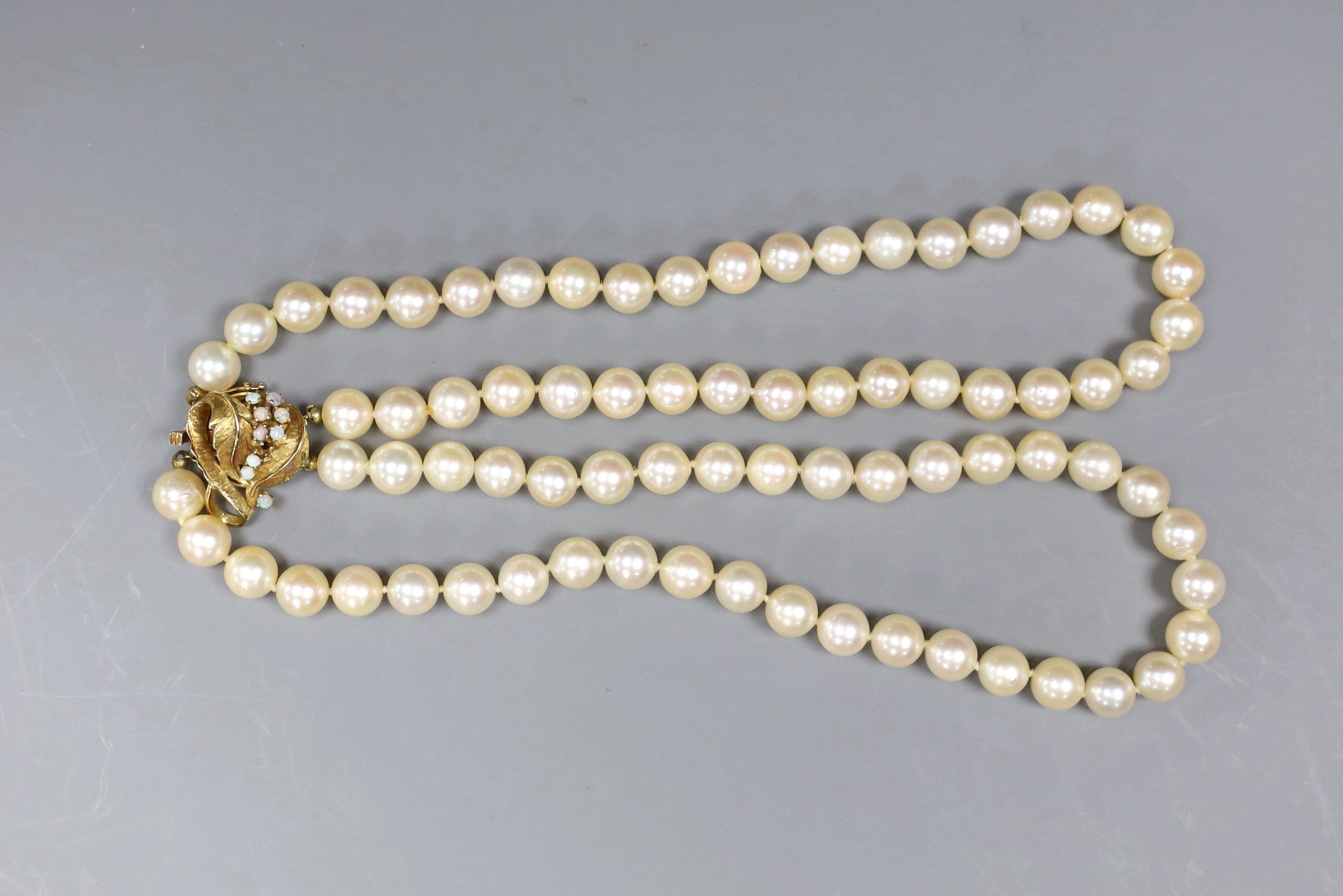 A two strand cultured pearl necklace, with white opal set 14ct gold clasp, 35cm
